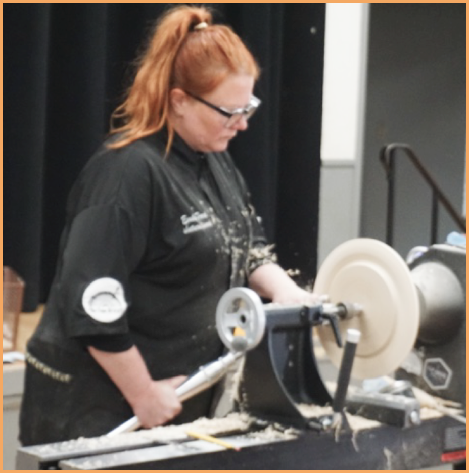 woman demonstrating wood carving